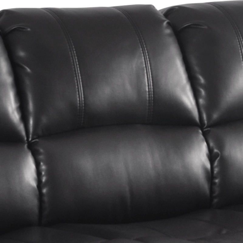 Close-up of a black leather sofa with visible stitching