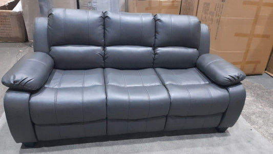 Gray leather sofa in a room with cardboard boxes