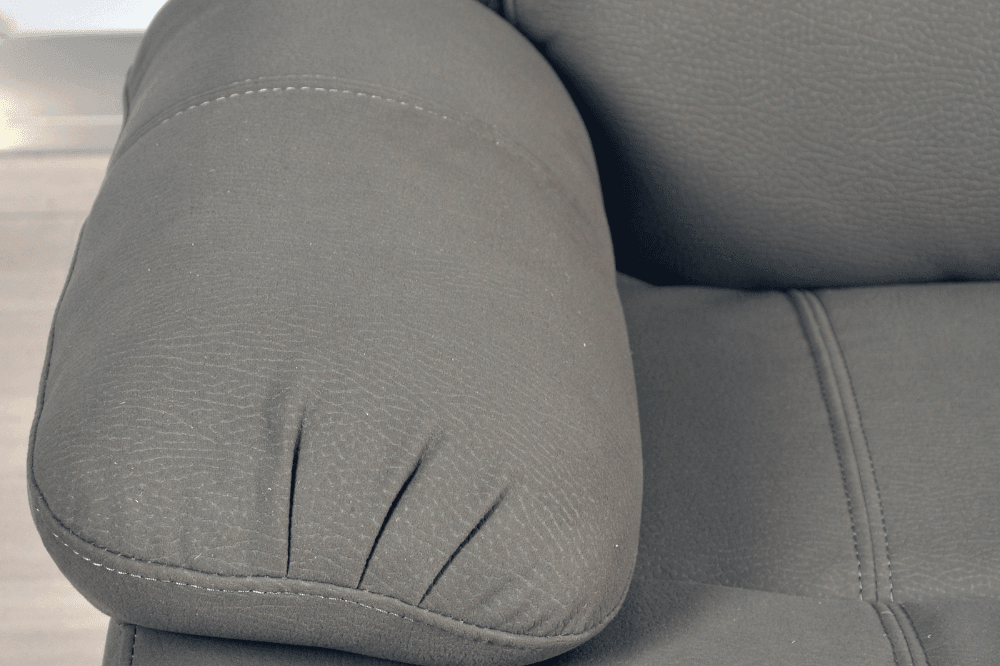 Close-up of modern light grey fabric sofa – textured upholstery detail of contemporary living room furniture