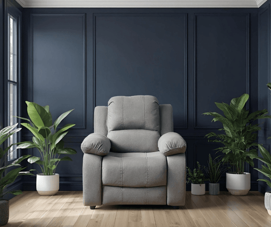 Gray armchair in a room with dark blue paneled walls and potted plants.