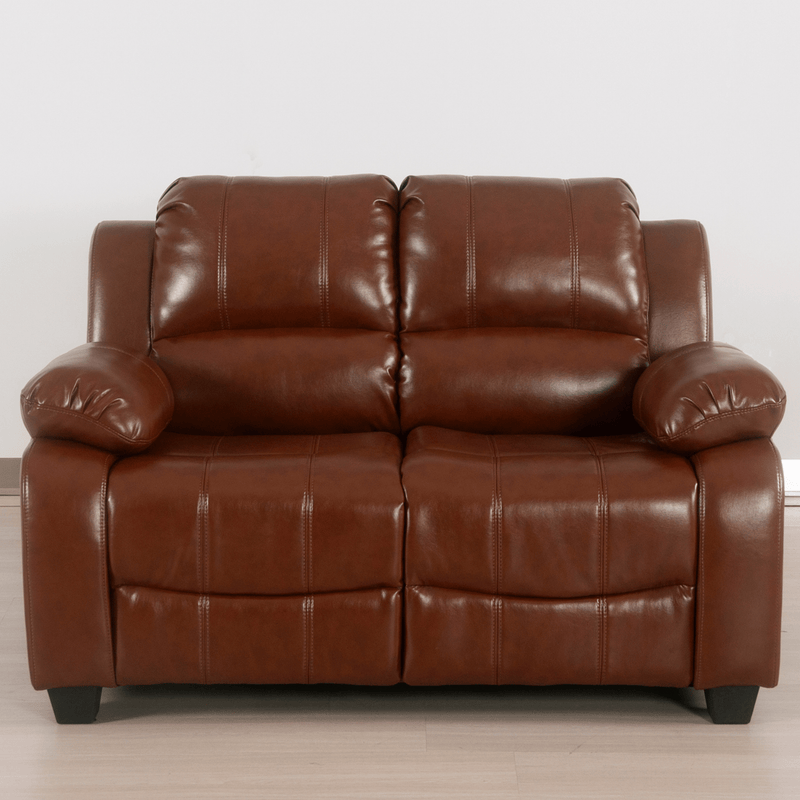 Brown leather sofa on a light wooden floor with a white wall background