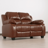 Brown leather sofa on a light wooden floor with a white wall background