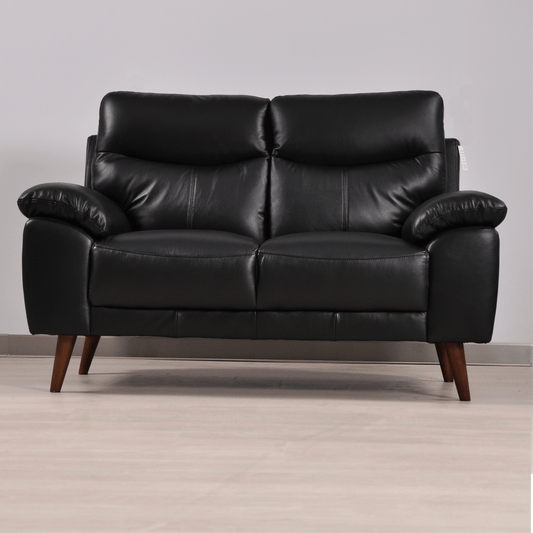 Vantage Black 2-Seater Sofa in a modern living room setting with stylish décor, soft lighting, and neutral tones