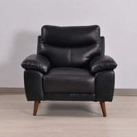 Vantage black armchair in a modern living room with neutral decor, warm lighting, and stylish accents