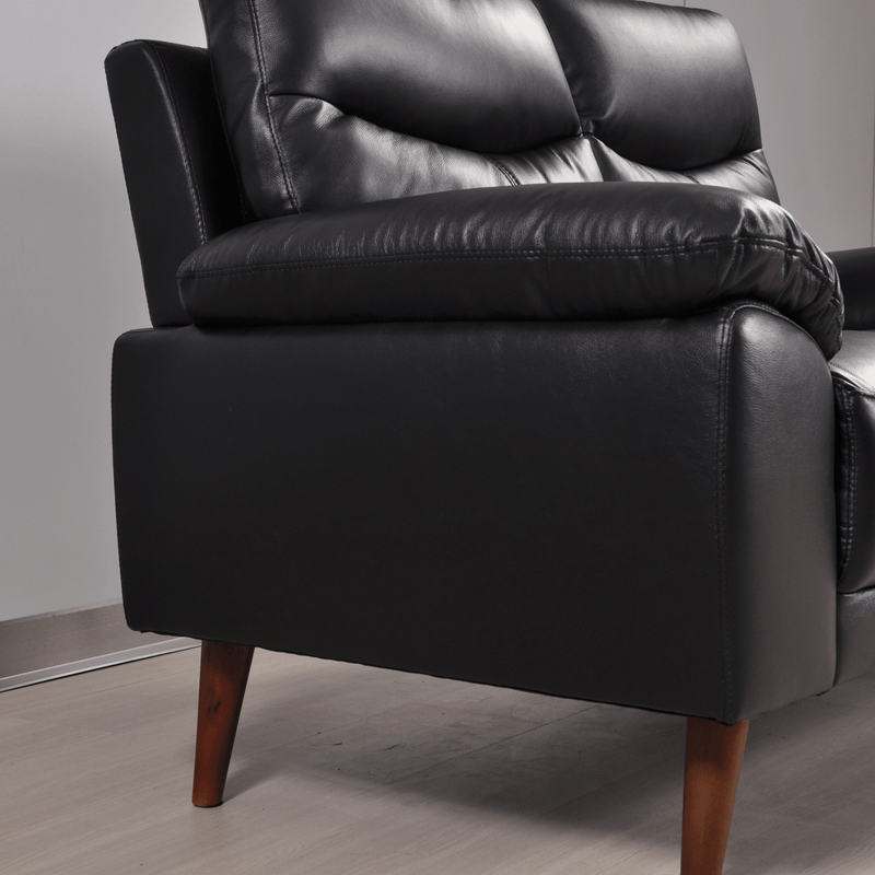 Close-up of Vantage black two-seater sofa showing detailed stitching and soft textured upholstery