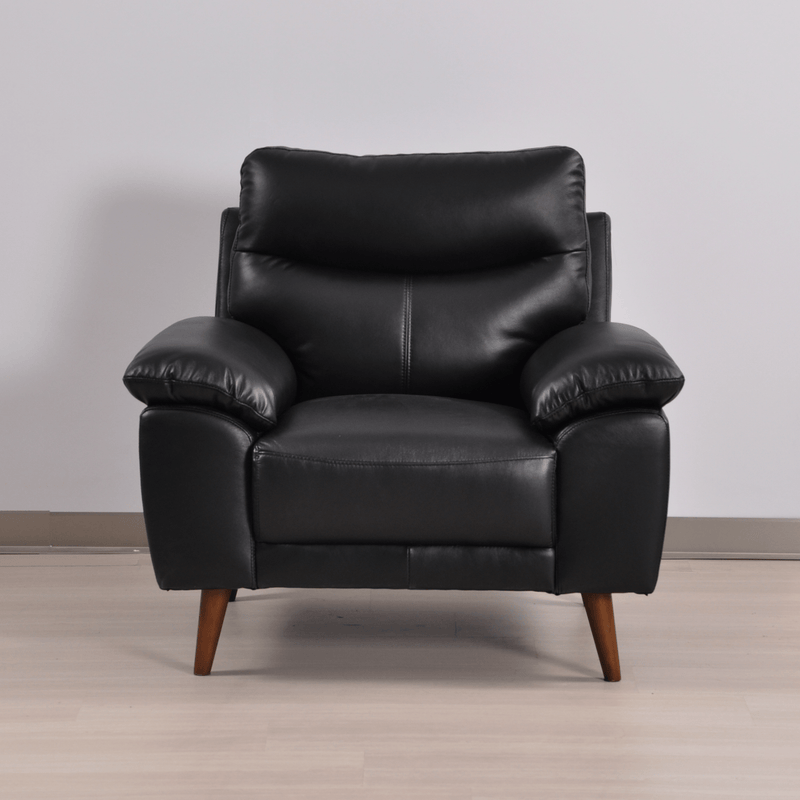 Vantage black armchair in a modern living room setting with soft lighting and neutral decor