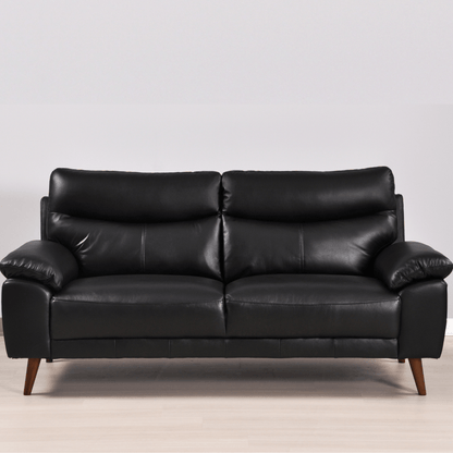 Vantage 3-seater black sofa in a modern living room set, front-facing view with decor and soft ambient lighting.