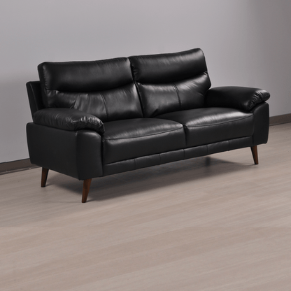 Vantage black 3-seater sofa at an angle in a modern living room with neutral decor and soft ambient lighting