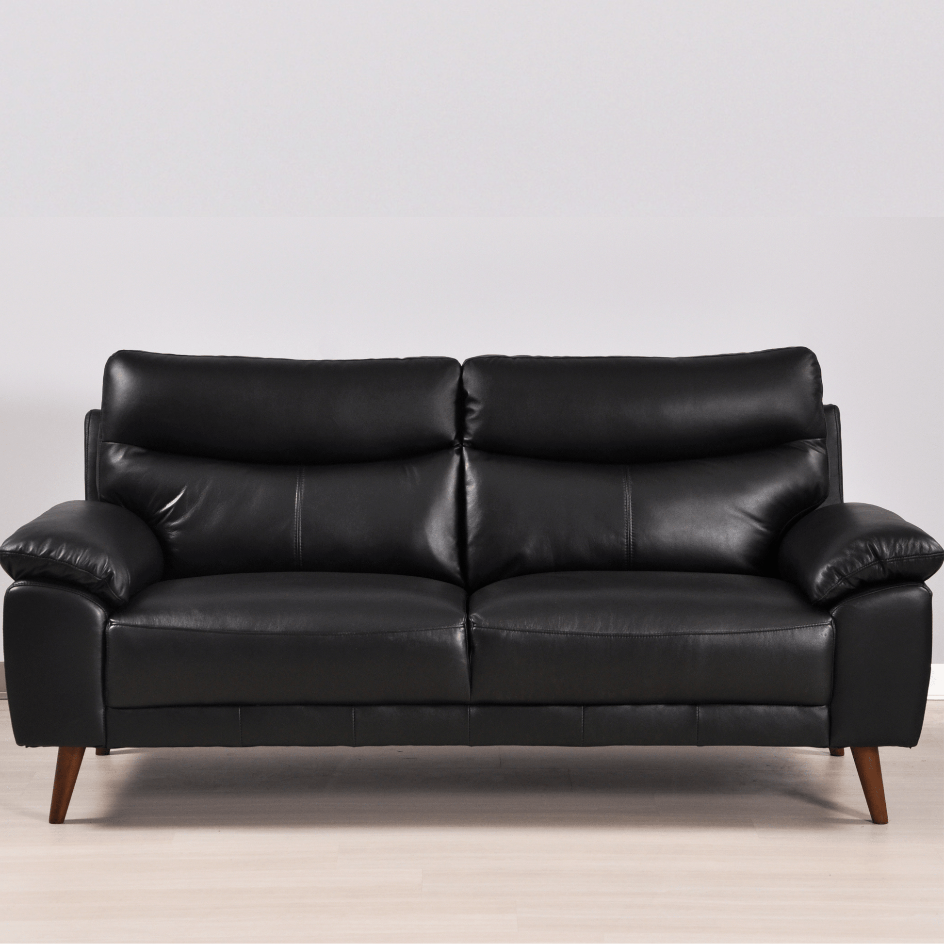 Vantage black 3-seater sofa in a modern living room with neutral decor and soft ambient lighting