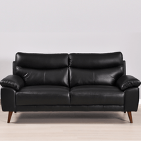 Vantage black 3-seater sofa in a modern living room with neutral decor and soft ambient lighting