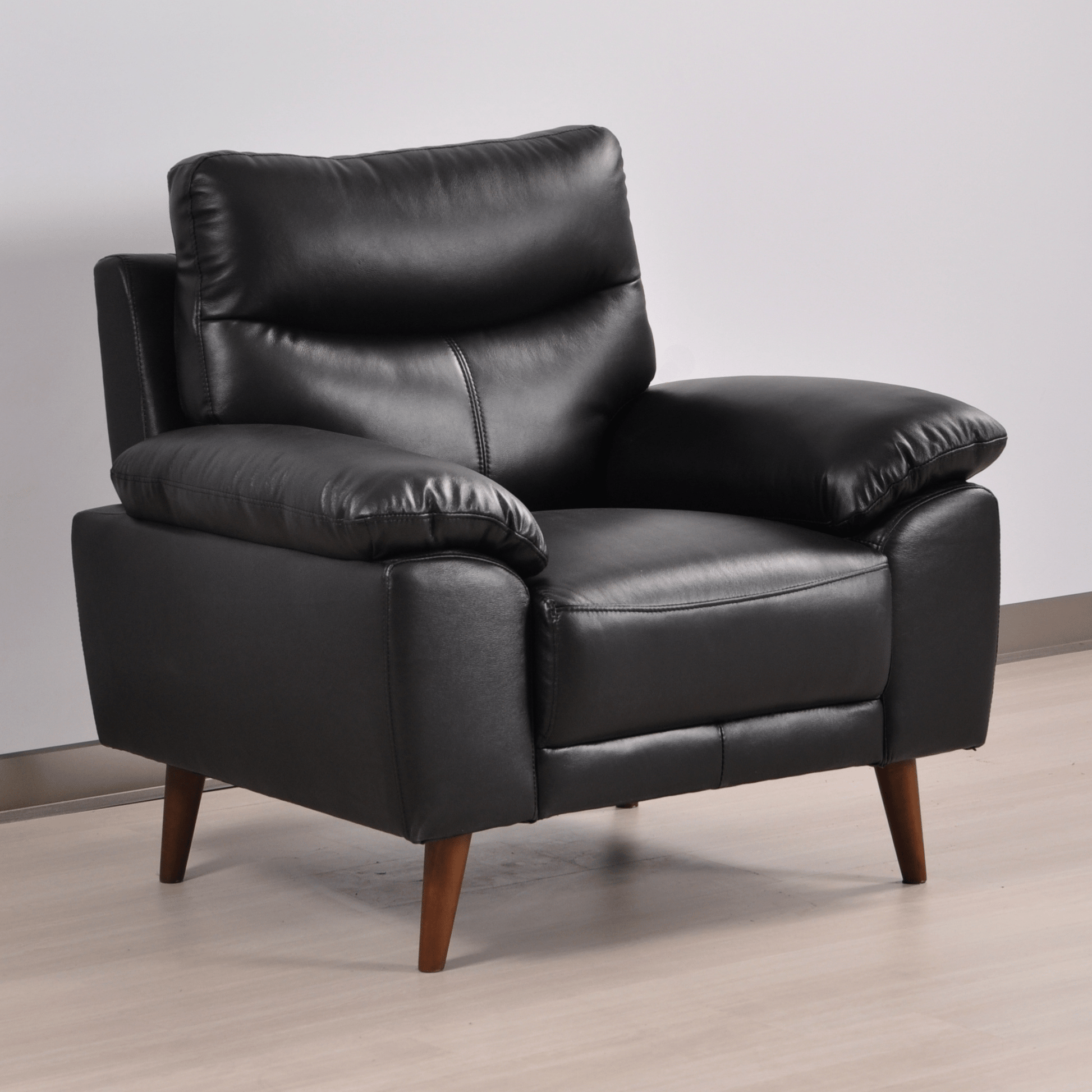 Vantage Black Armchair in a modern living room setting with contemporary décor, soft lighting, and neutral tones