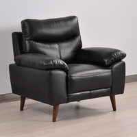 Vantage Black Armchair in a modern living room setting with contemporary décor, soft lighting, and neutral tones