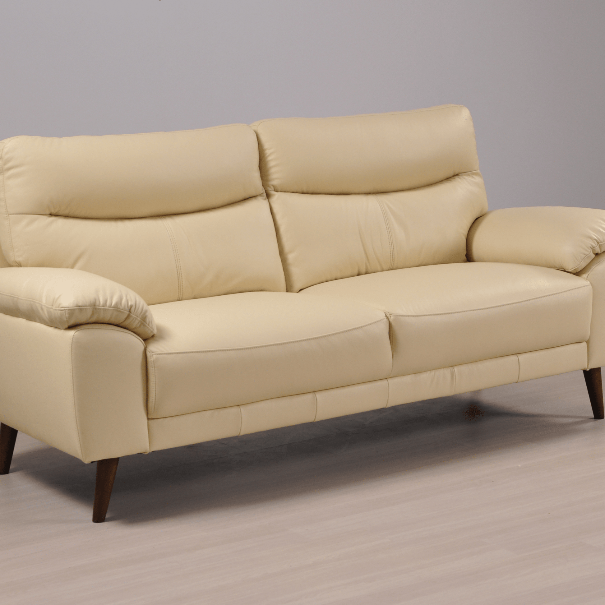 Angled view of the Vantage Cream 3-Seater Sofa in a modern living room setting with stylish décor and neutral tones