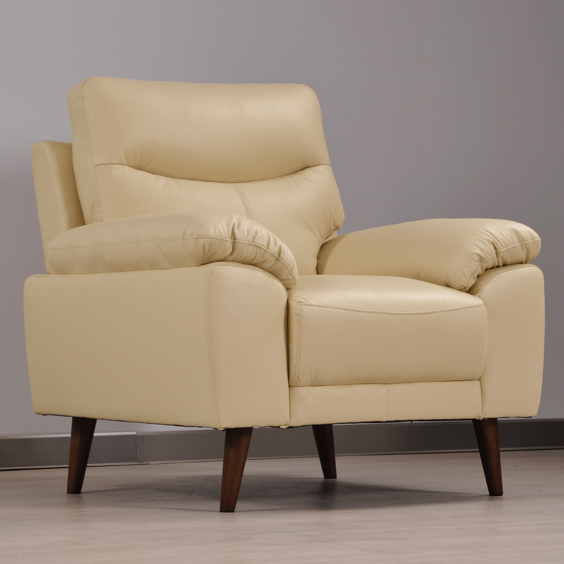 Vantage Cream armchair in styled living room, angled view, modern and cozy seating arrangement