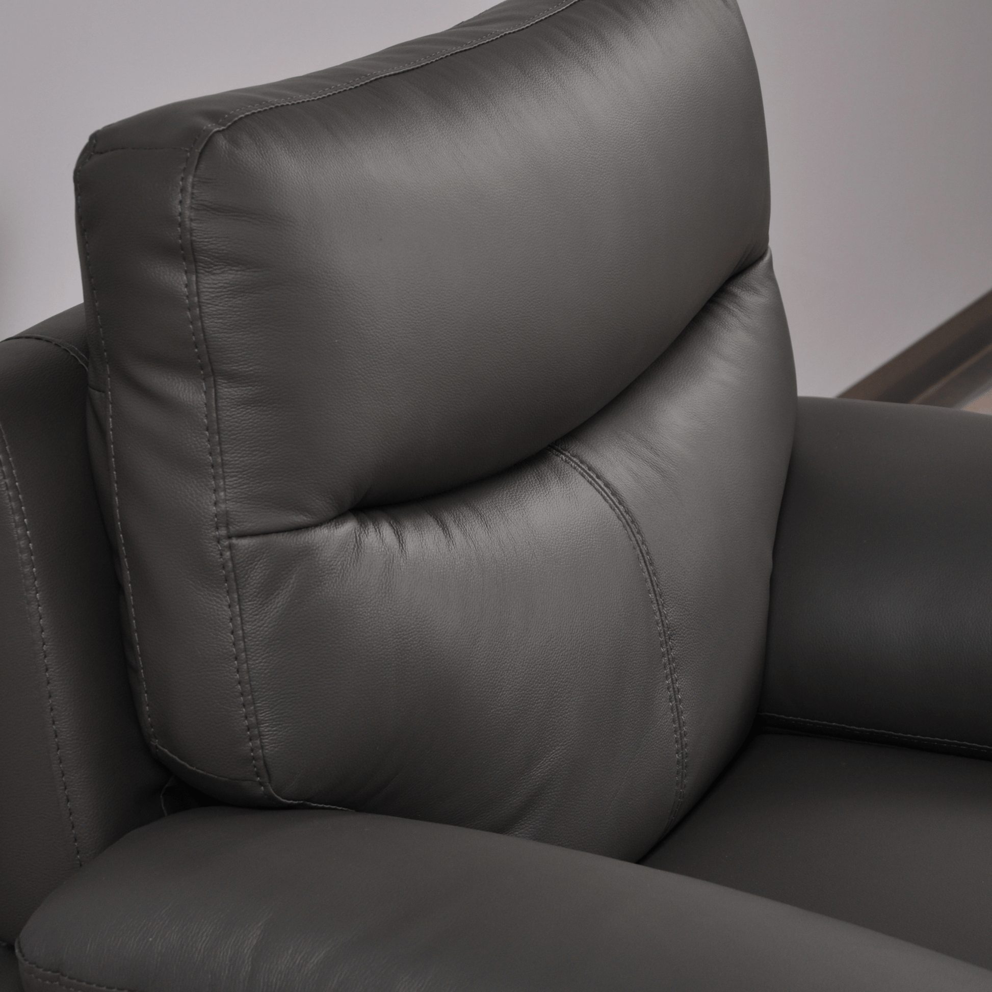 Vantage Grey Armchair close-up angled view in living room set, showcasing cushions, fabric texture, and contemporary design details