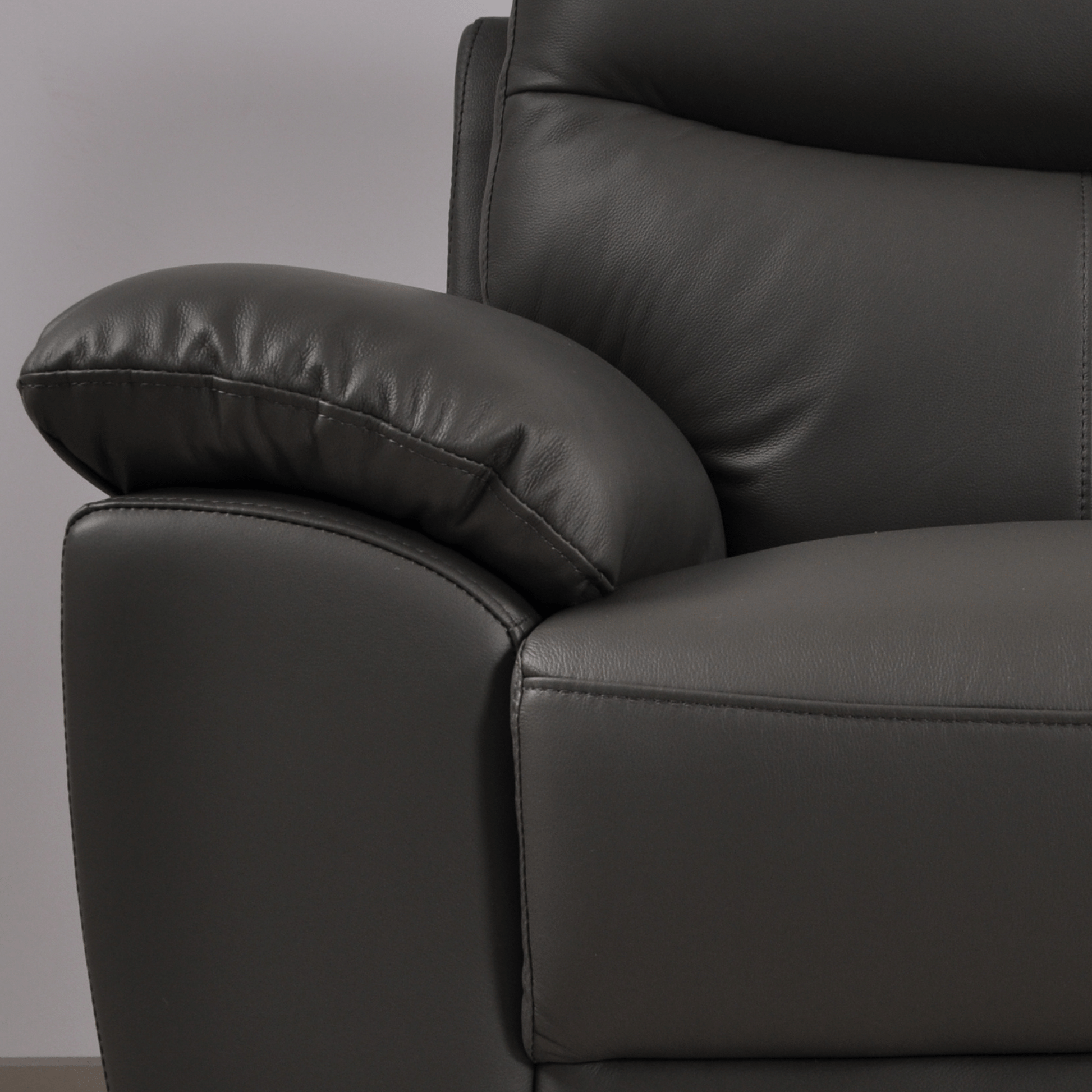Vantage Grey Armchair close-up in living room set, highlighting cushions, fabric texture, and modern design details