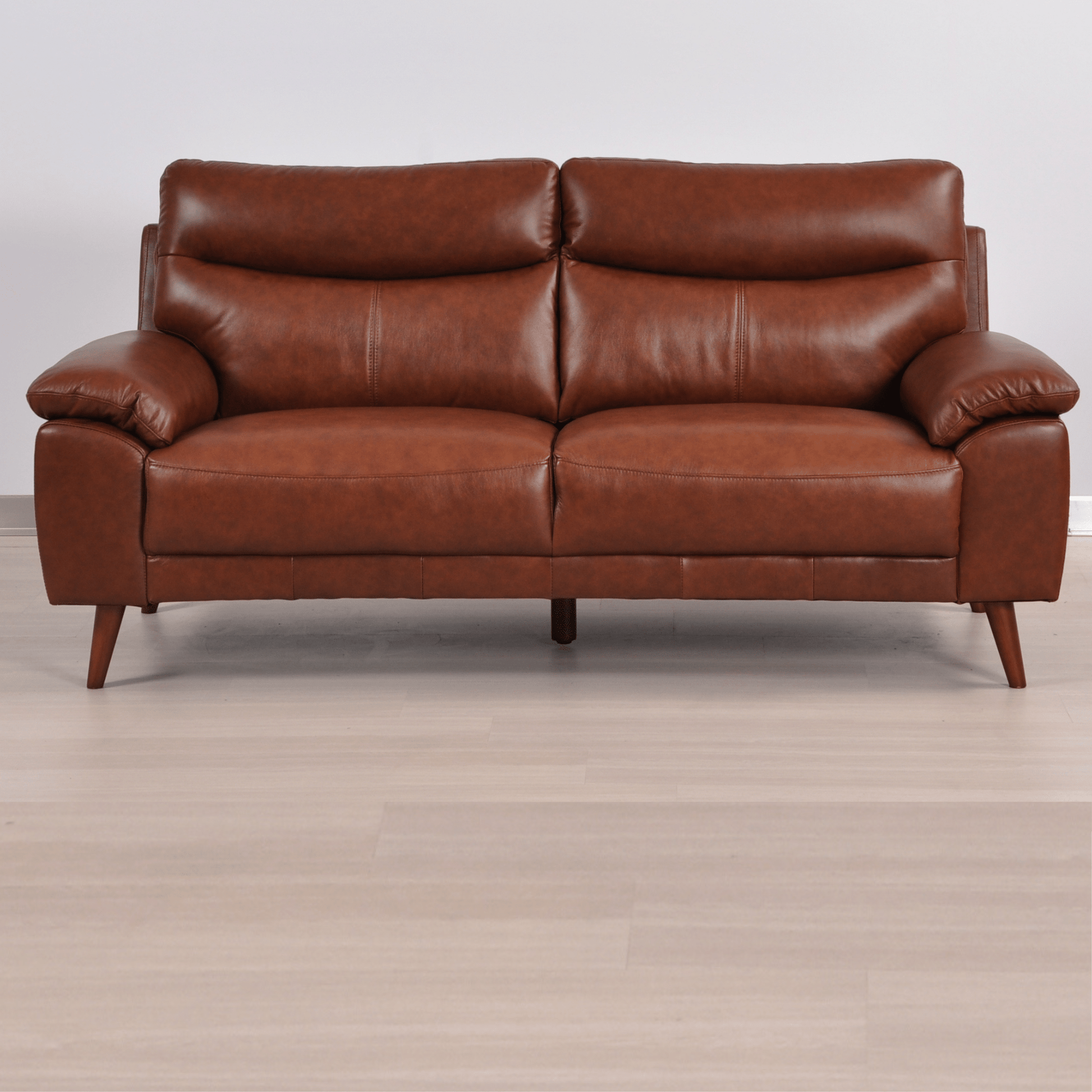 Vantage tan 3-seater sofa in a modern living room with neutral decor, warm lighting, and contemporary accents