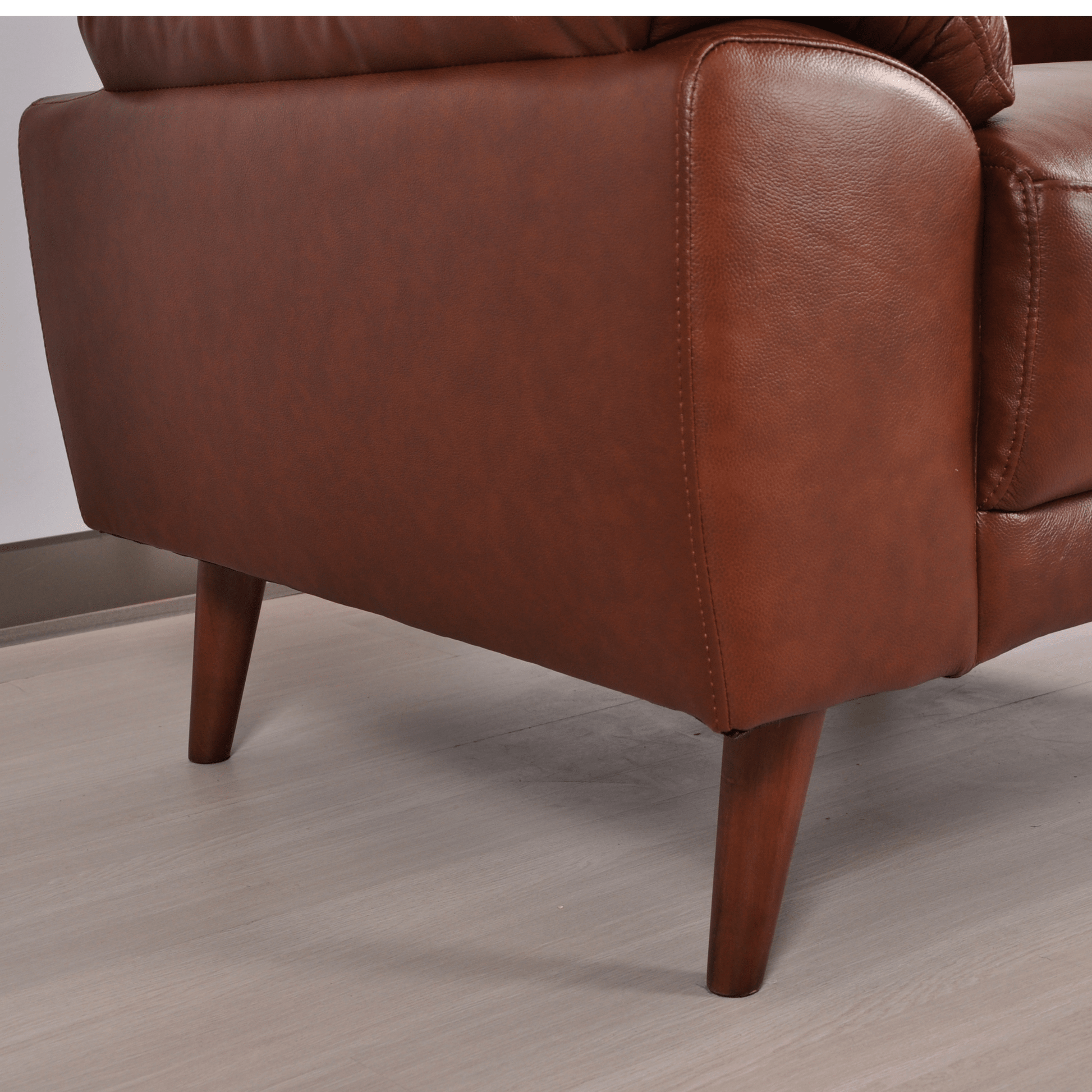Close-up of Vantage tan armchair showing plush upholstery and detailed stitching
