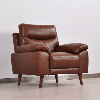Vantage tan armchair at an angle in a contemporary living room with neutral decor and soft lighting