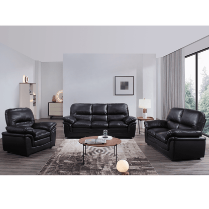 Black leather sofa set in a modern living room with a coffee table and decor items.