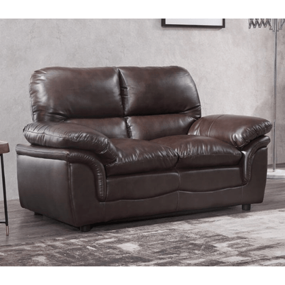 Brown leather sofa in a room with a neutral wall and rug.