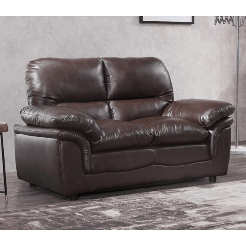 Brown leather sofa in a room with a neutral wall and rug.