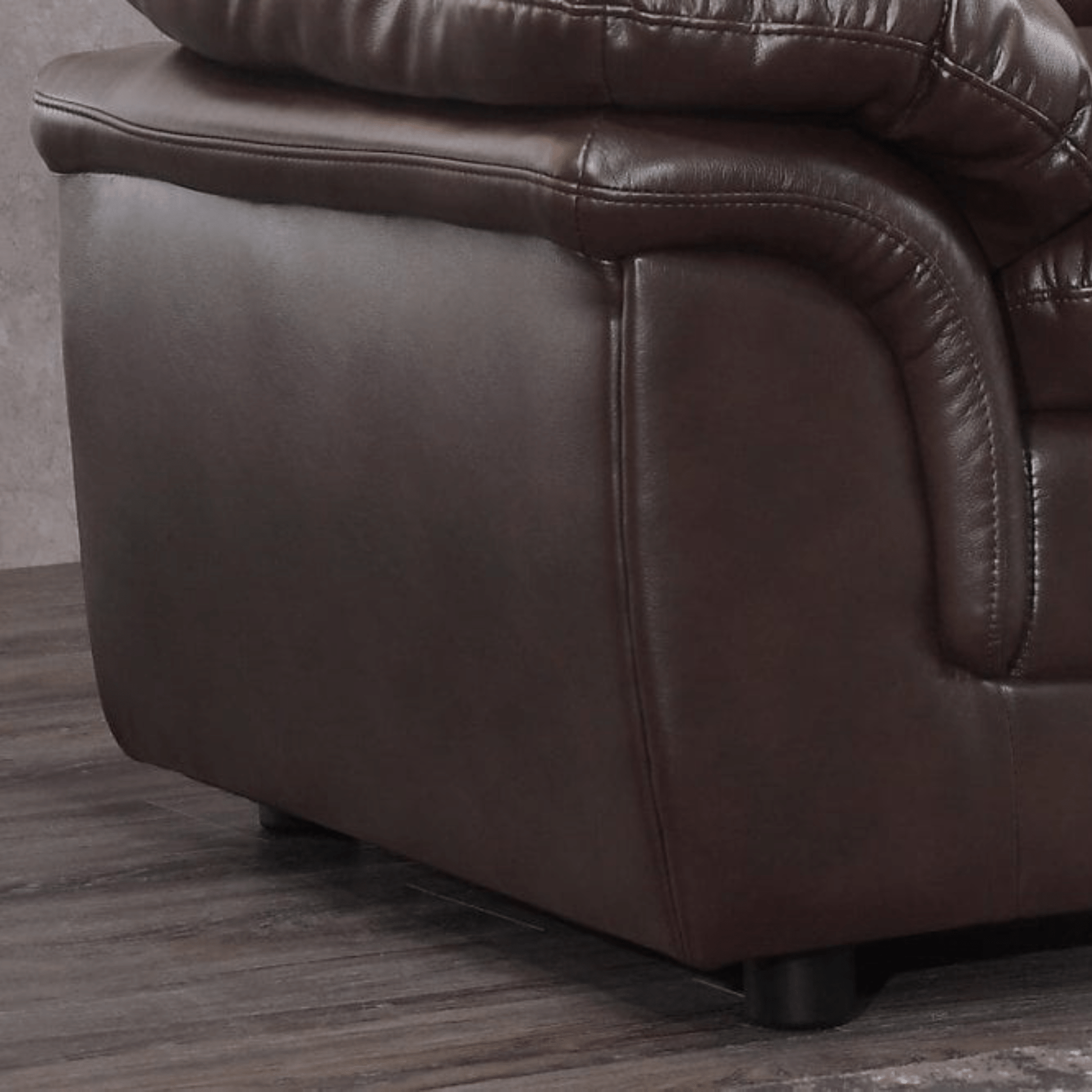 Brown leather recliner chair corner on a wooden floor