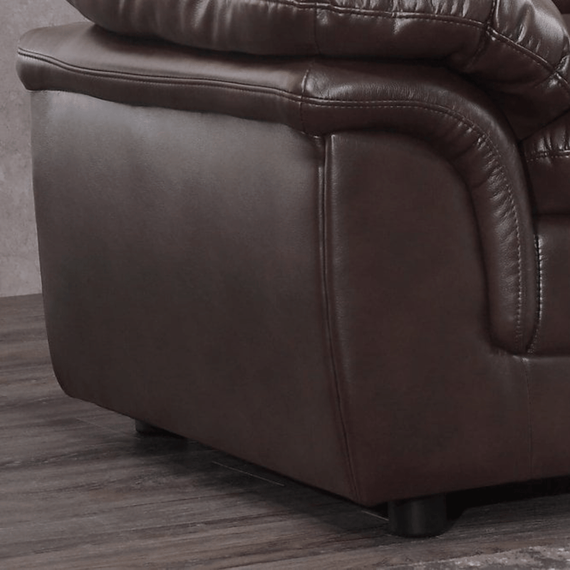 Brown leather recliner chair corner on a wooden floor