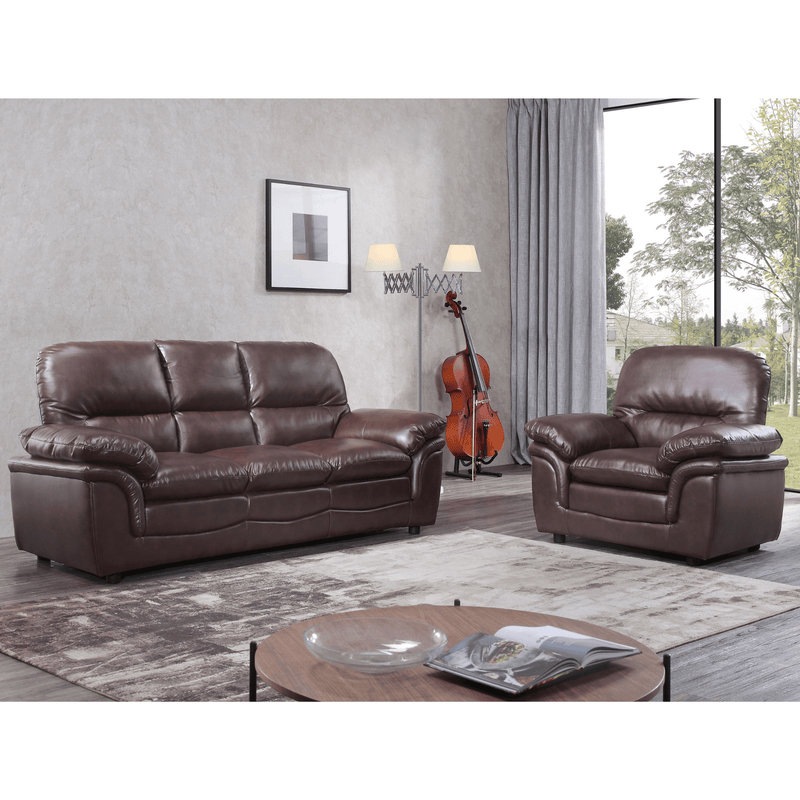 Brown leather sofa set in a living room with a guitar and lamp in the background.