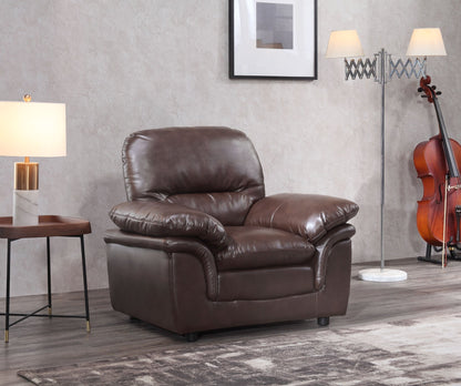 Brown leather armchair in a room with a gray wall, side table, and floor lamp.