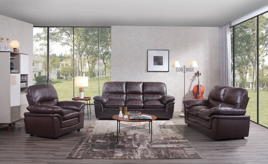 Brown leather sofa set in a modern living room with large windows.