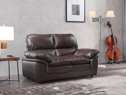 Brown leather sofa in a living room setting with a cello and lamp.