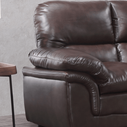 Brown leather recliner chair against a gray wall