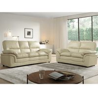 Beige leather sofa set in a modern living room with a coffee table and decor.