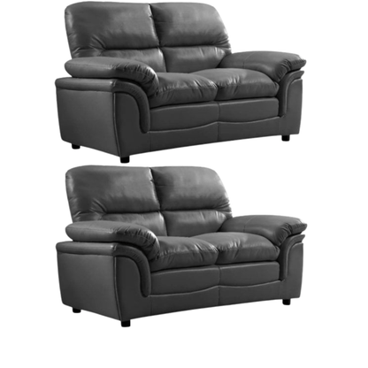 Two black leather sofas on a white background