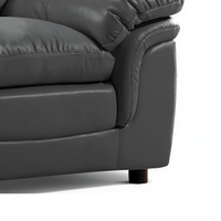 Gray leather sofa corner on a white background close up