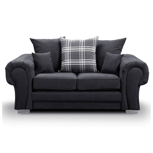 Gray sofa with plaid pillow on a white background