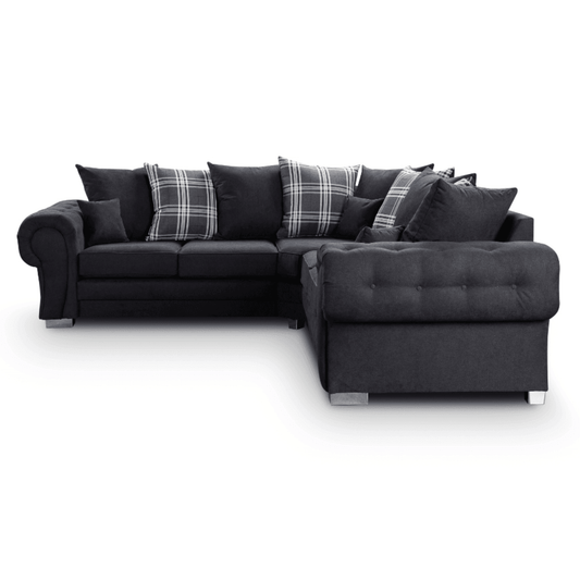 Gray sectional sofa with plaid cushions on a white background