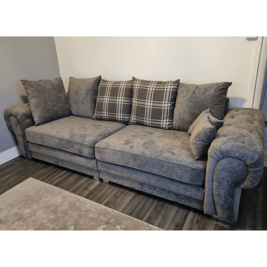 Gray sofa with patterned cushions in a room setting