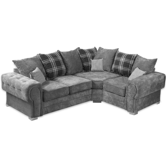 Gray sectional sofa with plaid cushions on a white background